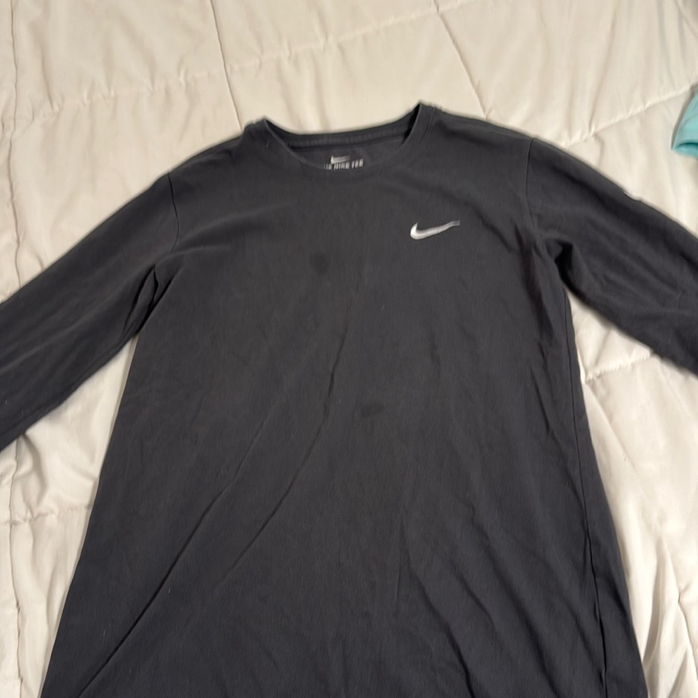 Grey long sleeve nike shirt. Has 2 small stains on the front.